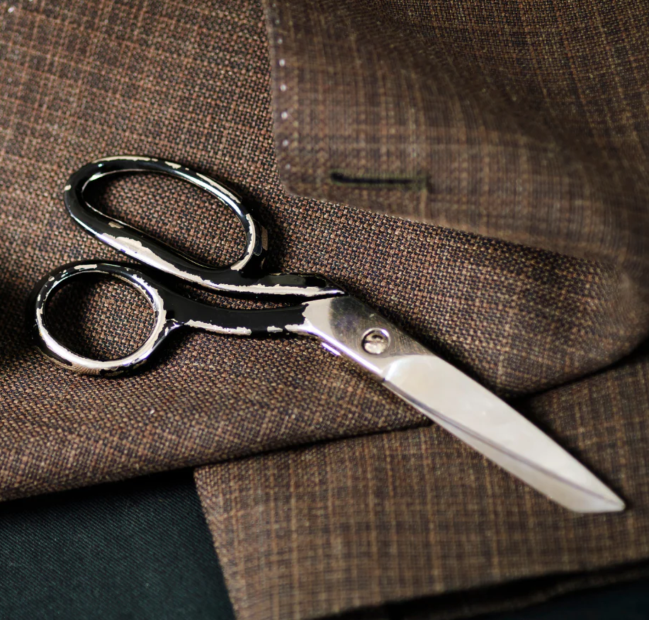 Master tailor's hands working on a white gown